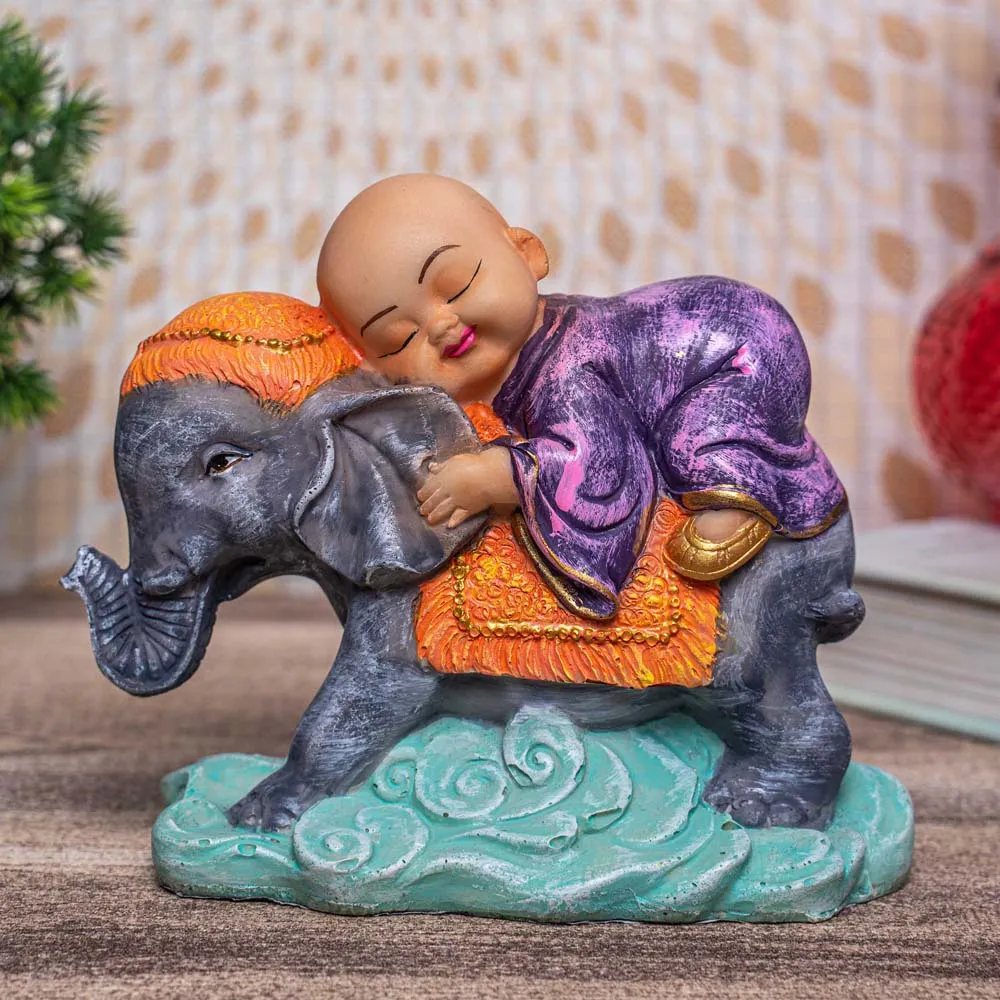 Cute Monk In Purple Sleeping On Blue Elephant Decorative Showpiece